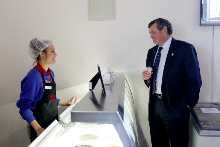 student helping customer at the ice cream counter