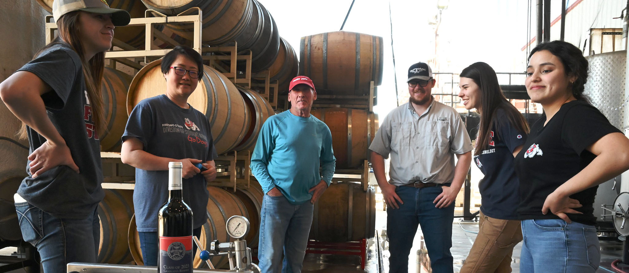 Winery students and faculty with grad reserve wine